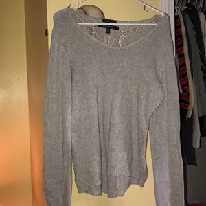 gray sweater with detailed back.